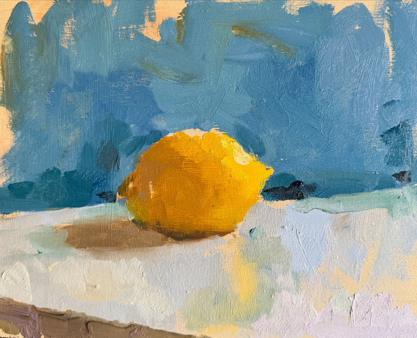 An oil painting of a lemon on a panel, with a predominantly blue background by Sarah Manolescue ROI